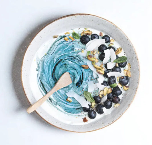 Ocean swirl yogurt bowl made with Greek yogurt, Elyxar superfood blend, berries, pistachios, chia, and coconut for gut health, energy, and antioxidants.