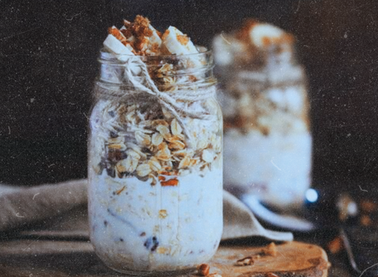 Banana bread overnight oats layered in jars with oats, banana, granola, and Elyxar Daily Superfood Complex for a creamy, functional breakfast.